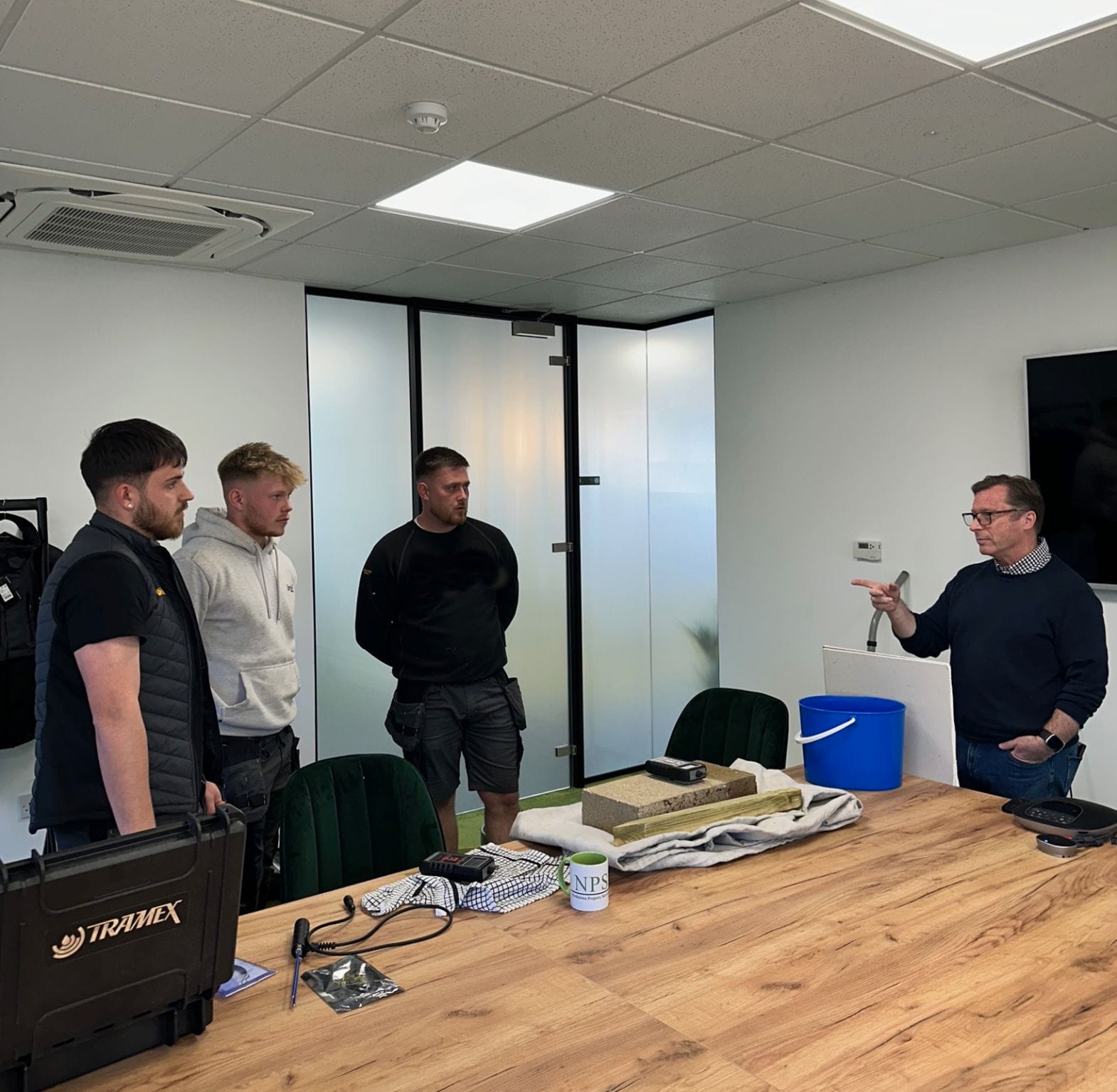 A class of tradesmen receiving mould training from an experienced mould and damp surveyor.